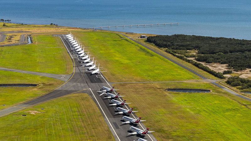 Aerial view of parked planes on Brisbane Airport's Runway 14/32, the decommissioning of which it brought forward to create additional parking space - free of charge - for grounded aircraft.